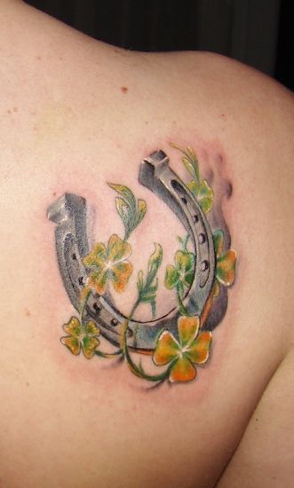 Yellow and green flowers with horse shoe tattoo - | TattooMagz › Tattoo