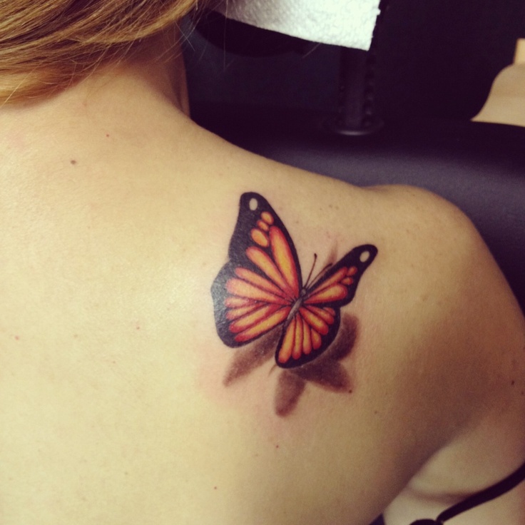 Yellow butterfly tattoo on shoulder