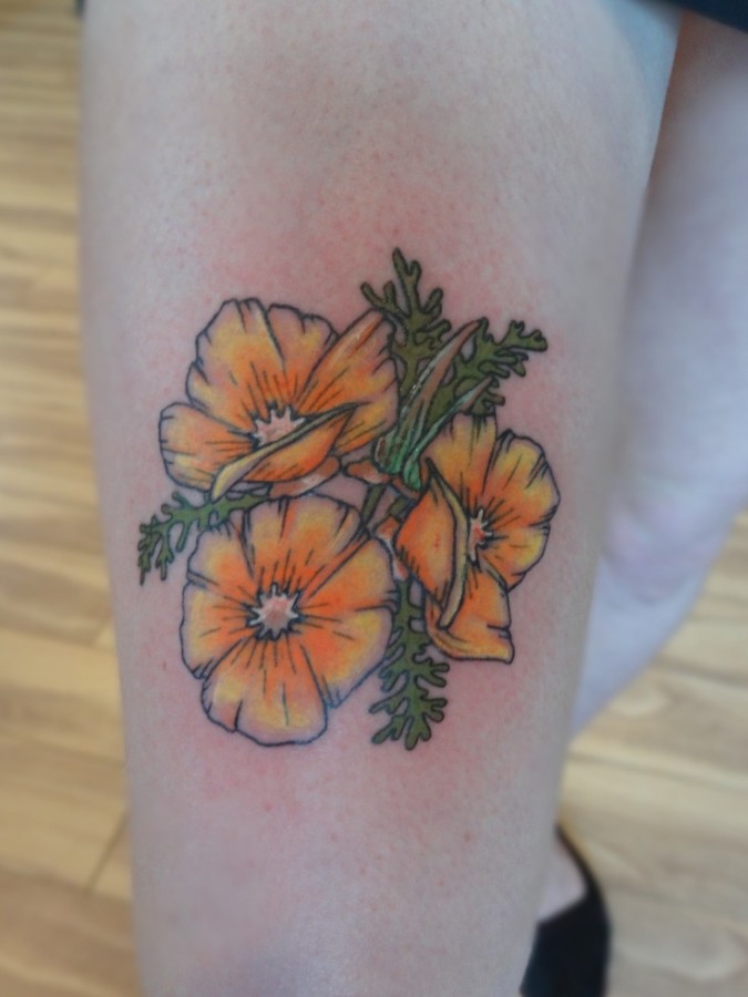 Yellow cute poppy tattoo on leg