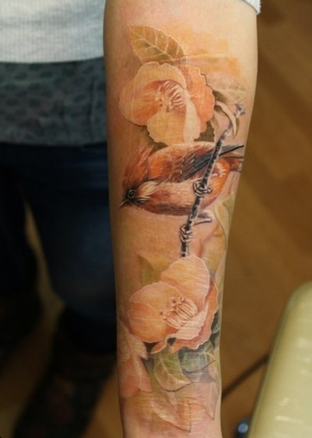 Yellow rose and brown bird tattoo on arm