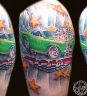 Yellow stars and green car tattoo on arm