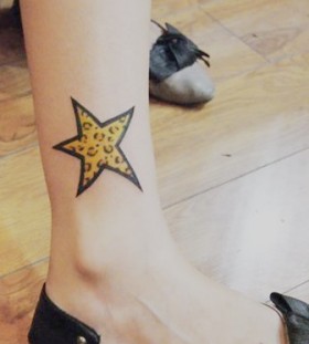 Yellow tiger star tattoo on leg