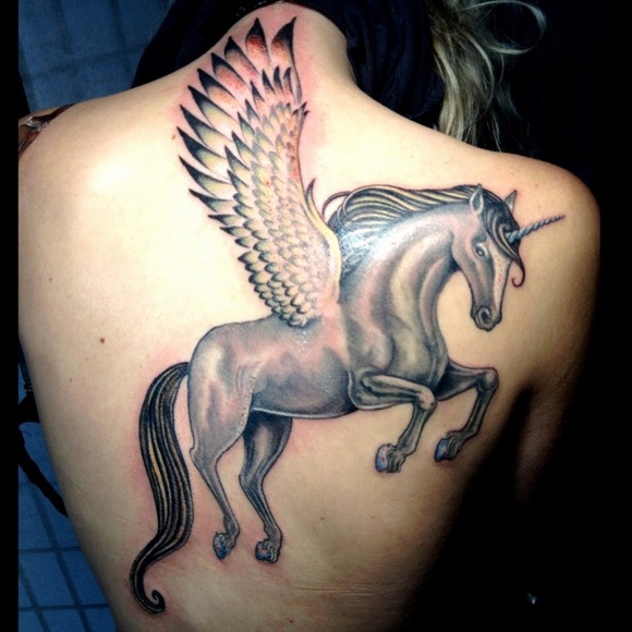 large unicorn tattoo with the wings on the back