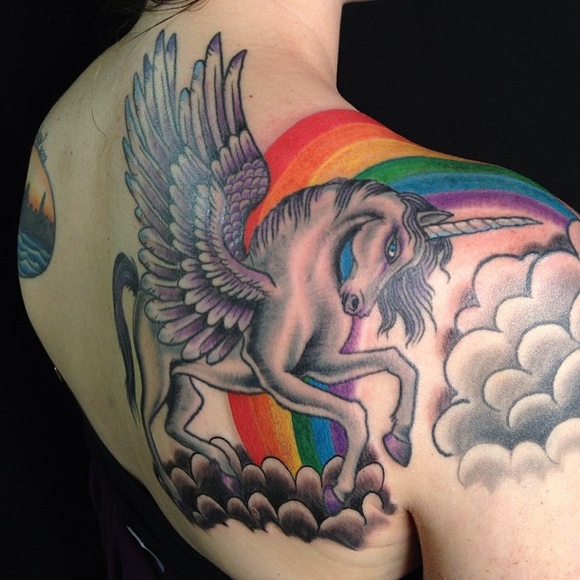 unicorn tatto with rainbow on the back