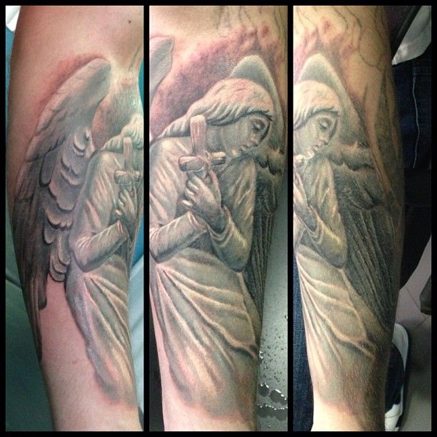 Adorable black angel tattoo on arm