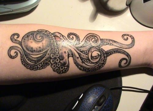 Adorable blue octopus tattoo on arm