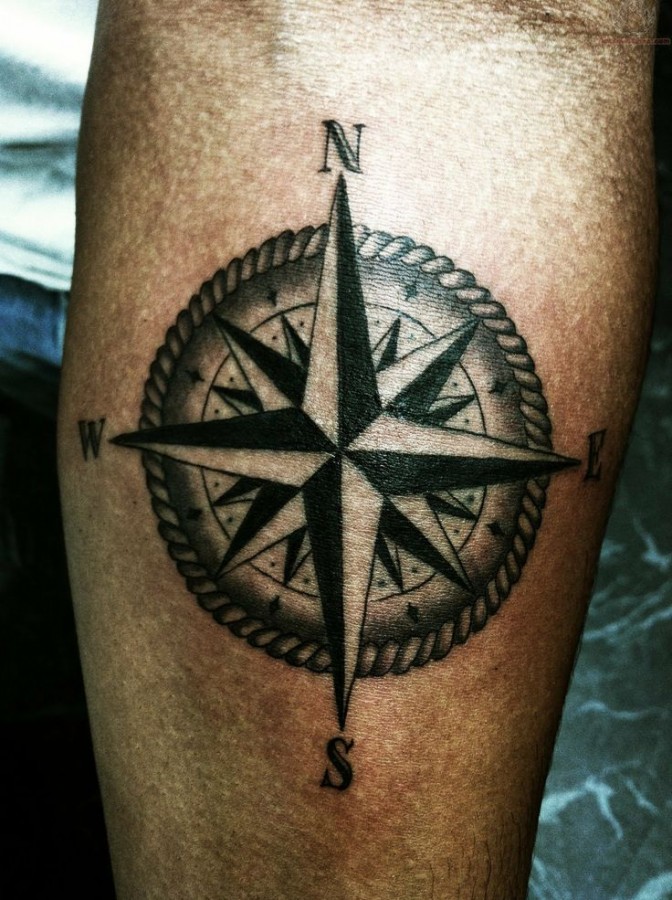 Awesome looking black compass tattoo on arm