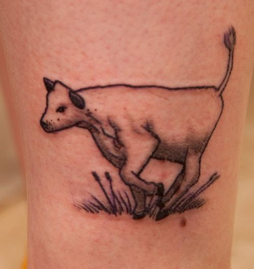 Black adorable cow tattoo