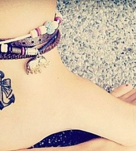 Black anchor girl tattoo on foot