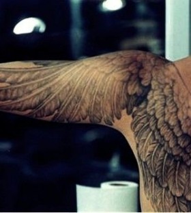 Black men's angel tattoo on shoulder