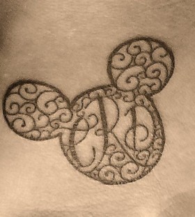 Black ornaments with Mickey Mouse tattoo on arm