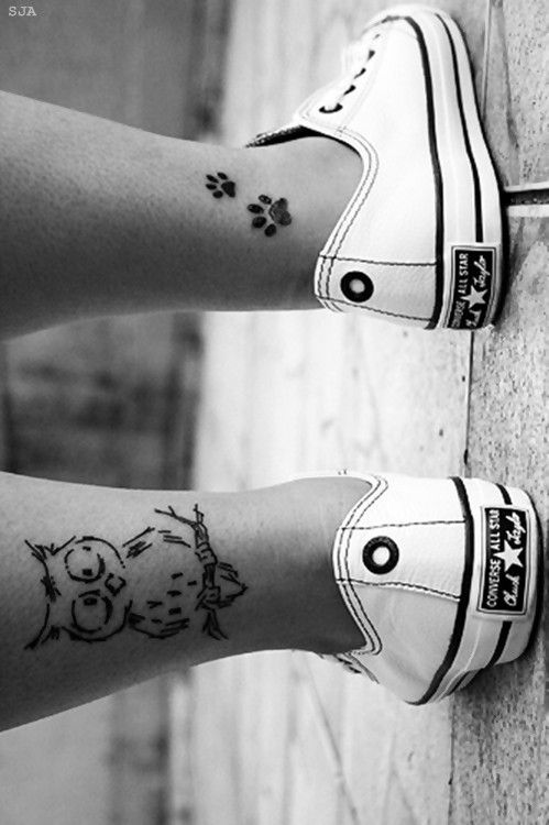 Black pawprints girl tattoo on leg