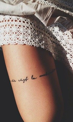 Black quote girl tattoo on leg