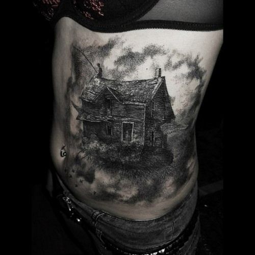 Black wolf’s and house tattoo