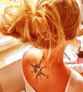 Blonde girl compass tattoo on back