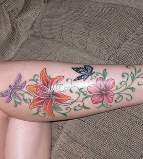 Colorful flowers and butterflies girl tattoo on leg