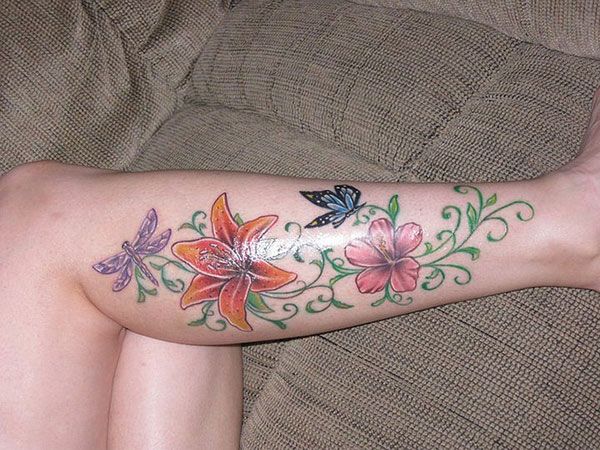 Colorful flowers and butterflies girl tattoo on leg