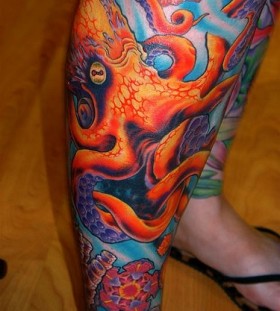 Colorful red octopus tattoo on leg