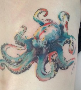 Colorful small octopus tattoo on arm
