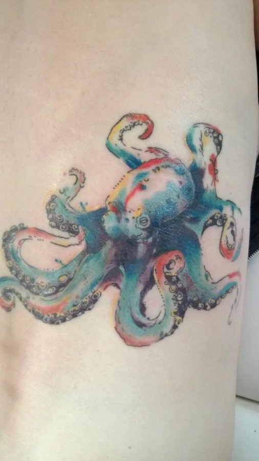 Colorful small octopus tattoo on arm