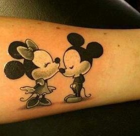 Couple kiss Mickey Mouse tattoo on leg
