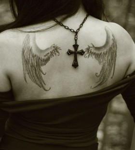 Cross and black angel tattoo on shoulder