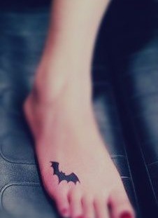 Funny batman girl tattoo on foot