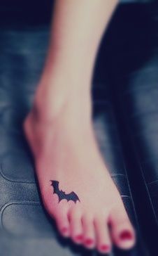 Funny batman girl tattoo on foot