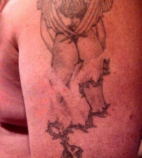 Gorgeous black girl's angel tattoo on arm