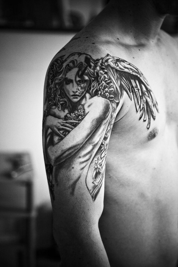 Gorgeous girl’s angel tatoo on arm
