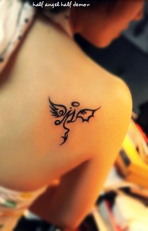 Gorgeous girl’s angel tattoo on shoulder