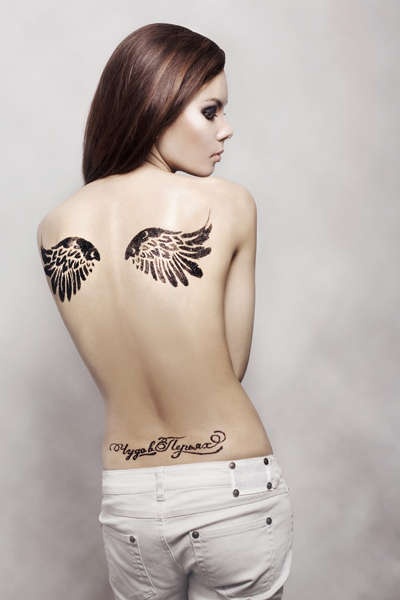 Great looking girl’s angel tattoo on shoulder