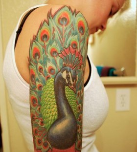Great looking peacock green tattoo