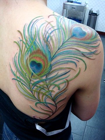 Green feather of peacock tattoo