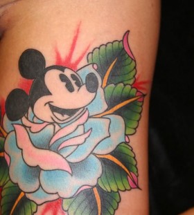 Green leafs and Mickey Mouse tattoo on leg