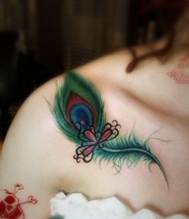 Green peacock style angel tattoo on shoulder