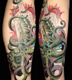 Green ship and octopus tattoo on leg