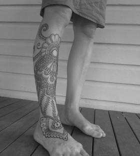 Lace and black octopus tattoo on leg