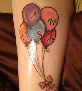 Letters and colorful balloon tattoo