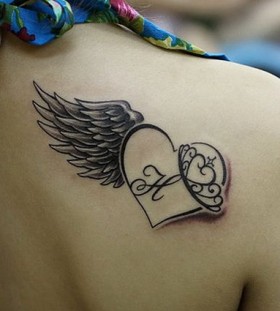 Letters, heart and angel tattoo on shoulder