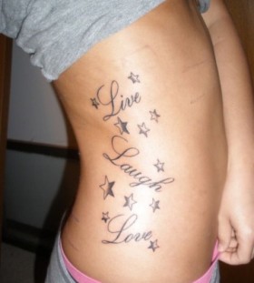 Live, laugh quote girl tattoo on hip