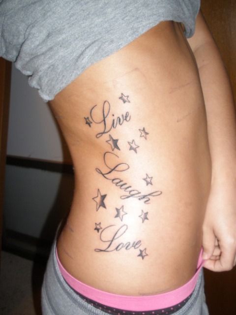 Live, laugh quote girl tattoo on hip