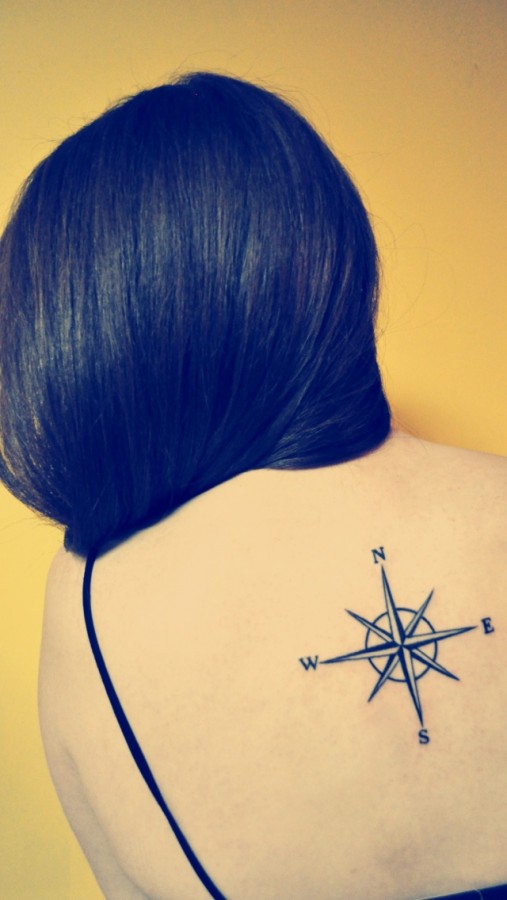Lovely women’s compass tattoo on back