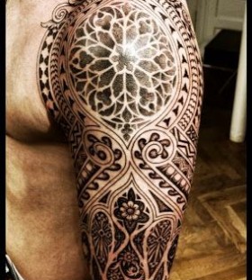 Men's black geometric arm tattoo