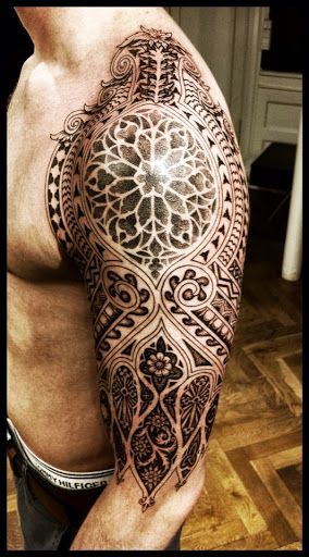 Men’s black geometric arm tattoo