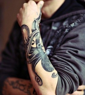 Men's black octopus tattoo on arm