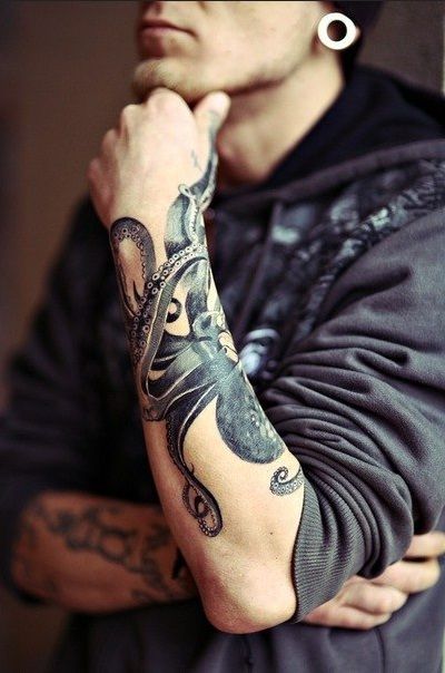 Men’s black octopus tattoo on arm