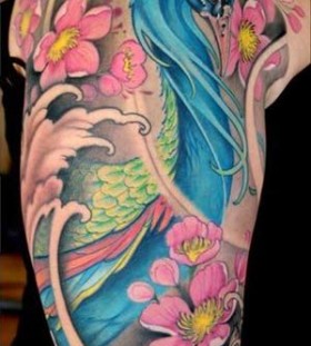 Pink flowers and blue peacock tattoo