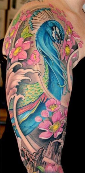 Pink flowers and blue peacock tattoo