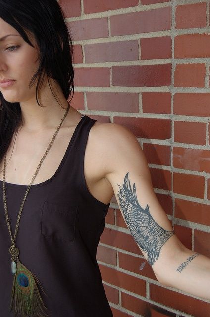 Pretty girl’s black geometric arm tattoo